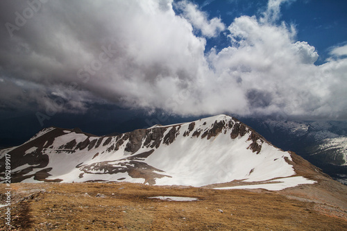 one of the snow-capped peaks of mount under a cloudy sky photo