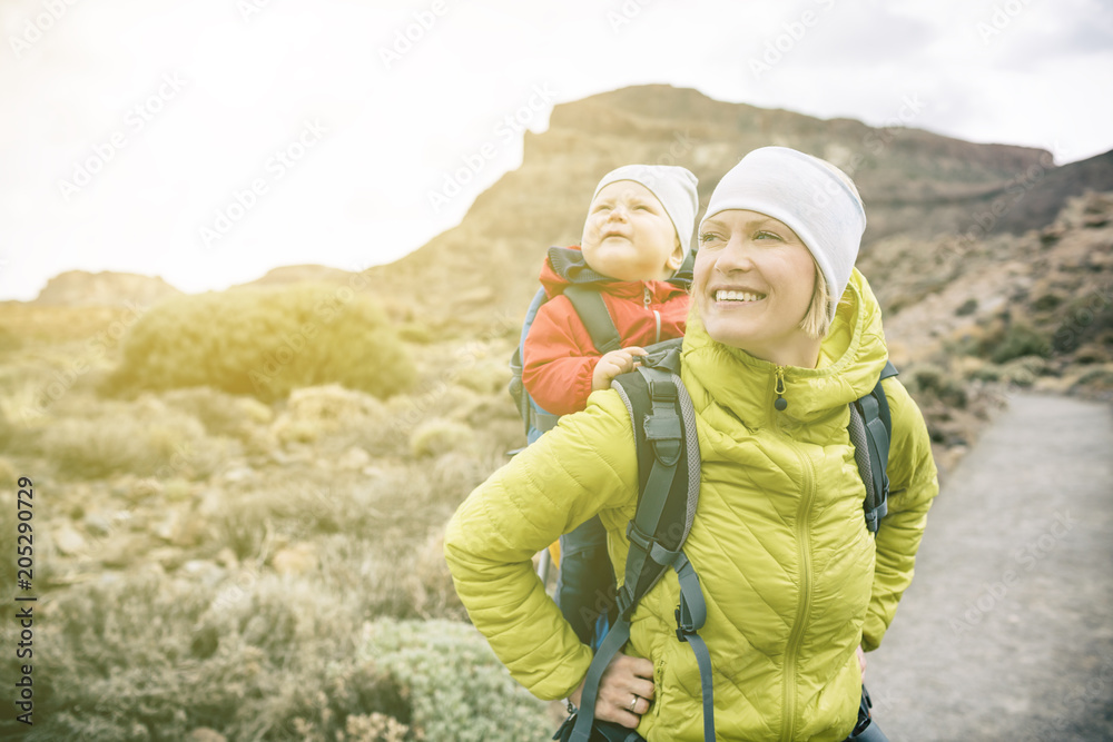 Super Mom with baby boy hiking in backpack Super Mom with baby boy hiking in backpack