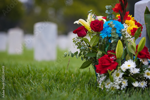 white grave markers and flowers at a national cemetary