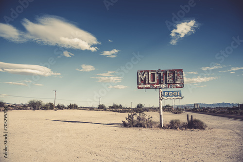 A dilapidated, classic, vintage motel sign in the desert of Arizona photo