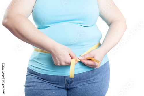 fat woman measuring her stomach (overweight, obesity). Isolated on white background.
