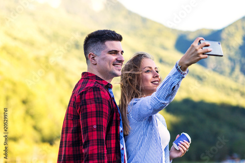 Cute young couple taking selfie outdoor