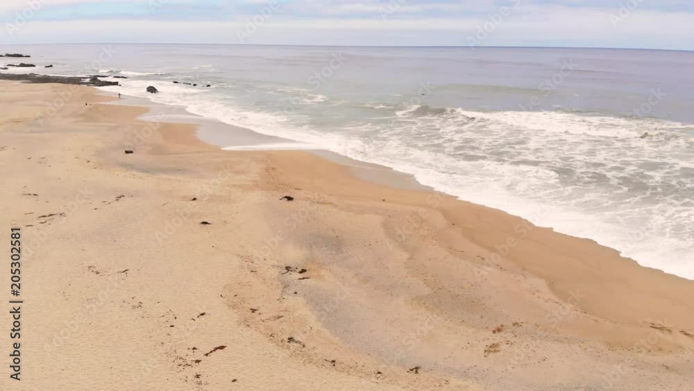 Aerial view of beautiful beach and waves in the ocean