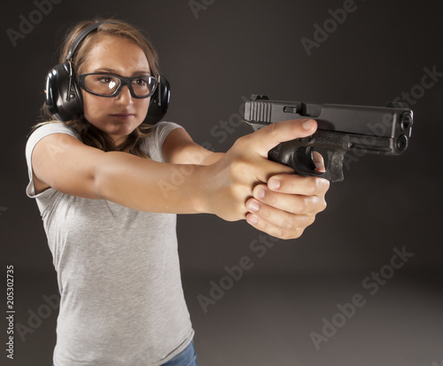 Young woman at shooting range. photo