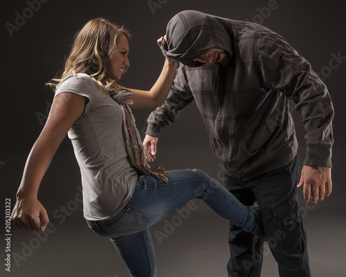 Teenage girl uses self defense skills to fight back. Fototapet