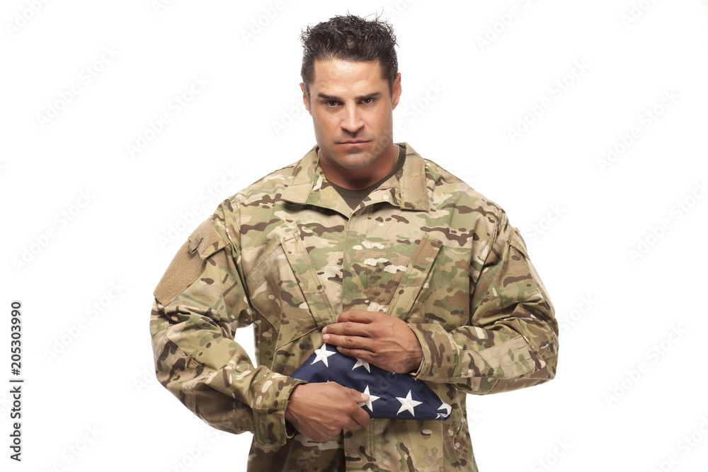 Soldier holding folded American flag