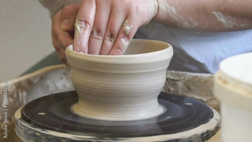 pottery handicraft skills. traditional art of creating ceramics. potter modeling clay on turning wheel pottery handicraft skills. traditional art of creating ceramics. potter modeling clay on turning wheel