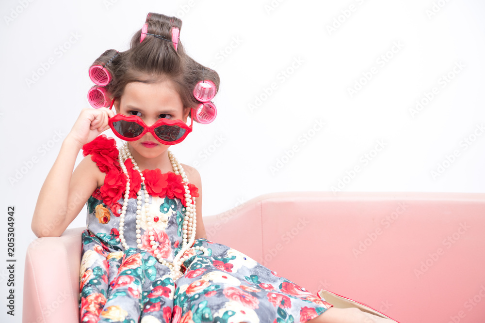 Young super model girl portrait. Pre teen girl dress up like a super model portrait. High heel red shoes, red sunglasses. Confident pose. Young super model girl portrait. Pre teen girl dress up like a super model portrait. High heel red shoes, red sunglasses. Confident pose.