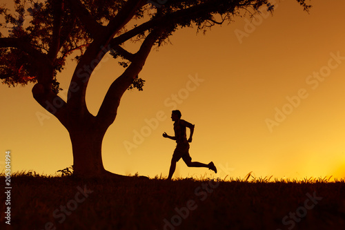 Silhouette of man running jogging outdoors. 