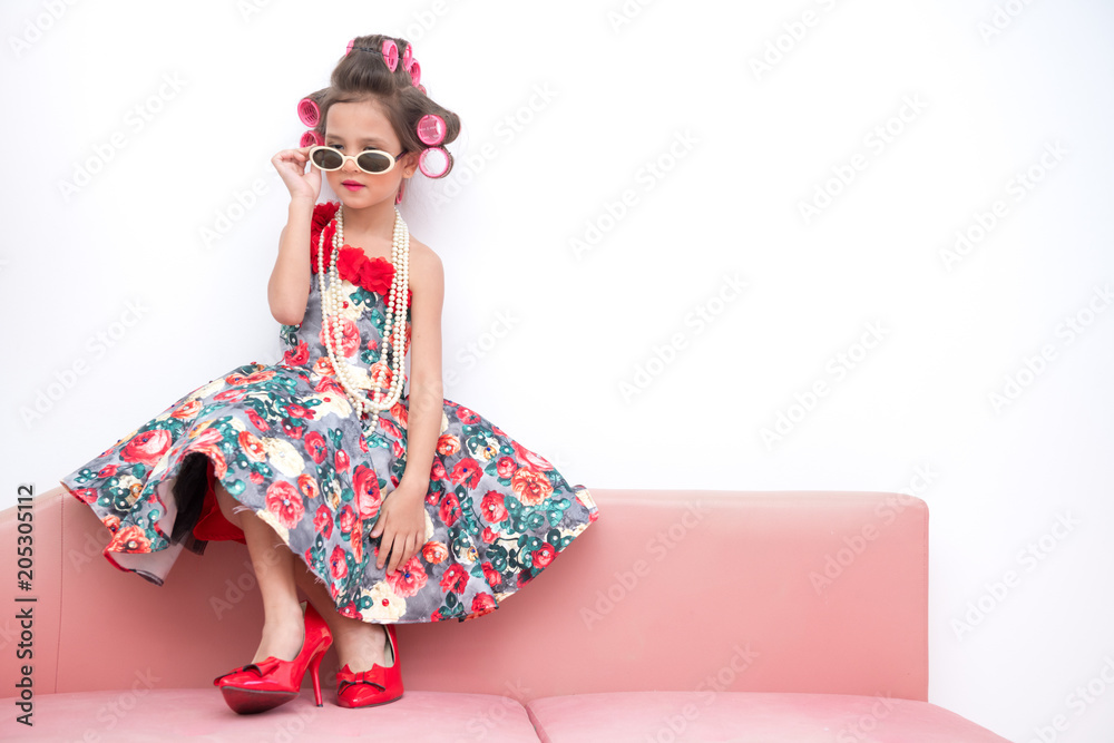 Young super model girl portrait. Pre teen girl dress up like a super model portrait. High heel red shoes, white sunglasses. Confident pose. Young super model girl portrait. Pre teen girl dress up like a super model portrait. High heel red shoes, white sunglasses. Confident pose.