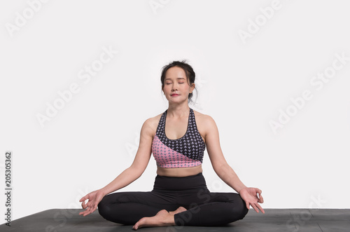Woman practicing yoga on a white background. 
