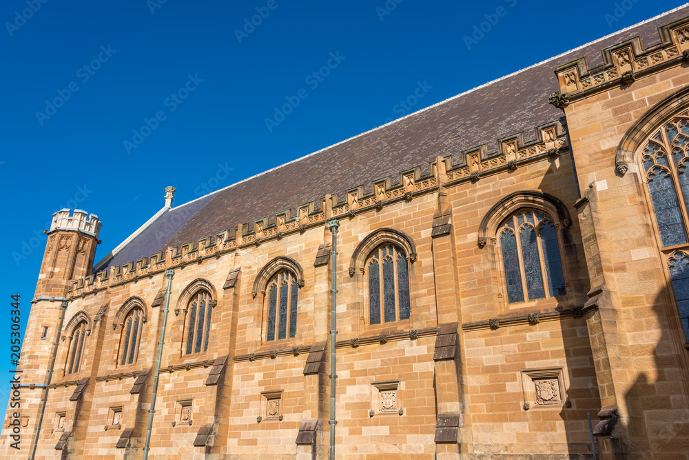 Sandstone gothic building with arch windows and decorations