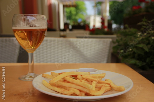 fried French fries on a plate on the wooden table