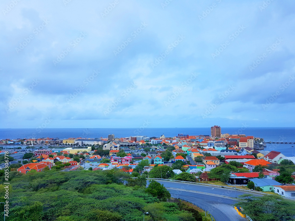 aerial view of the coastline city of Willemstad, capital of Curazao, with colorful buildings and blue sea and sky. aerial view of the coastline city of Willemstad, capital of Curazao, with colorful buildings and blue sea and sky.