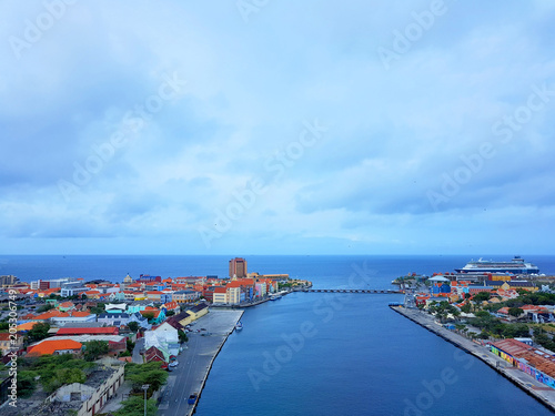 aerial view of the coastline city of Willemstad, capital of Curazao, with colorful buildings and blue sea and sky. photo