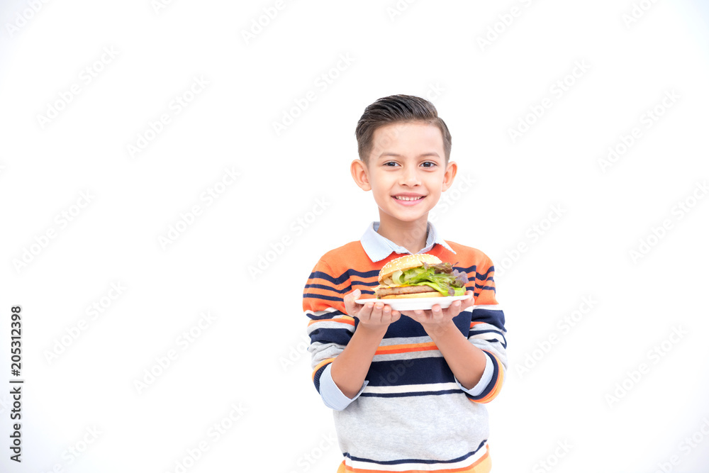 Young boy with burger isolated in white. Handsome early teenage boy portrait. Holding a burger. Happy smile face. Young boy with burger isolated in white. Handsome early teenage boy portrait. Holding a burger. Happy smile face.