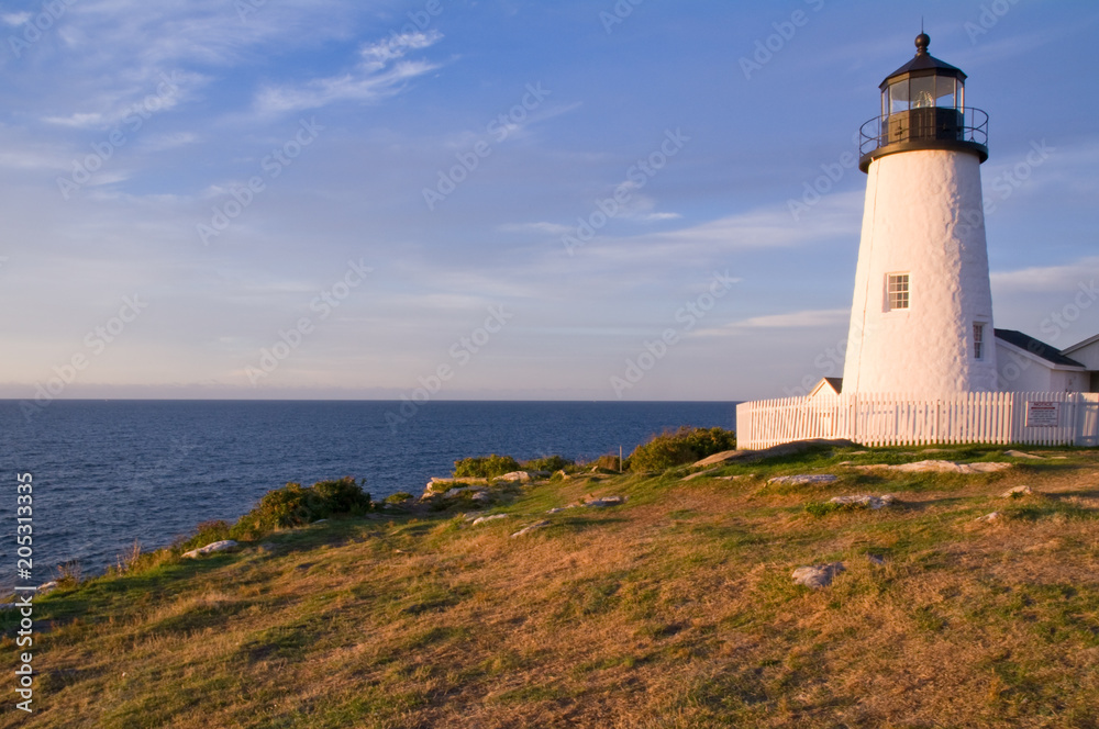White Lighthouse On Shore in Early Morning