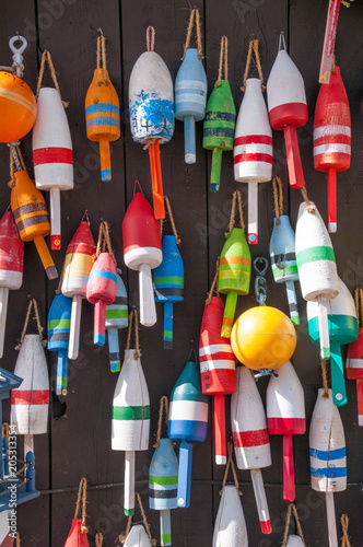 Colorful Fishing Buoys Hanging on Outdoor Wall