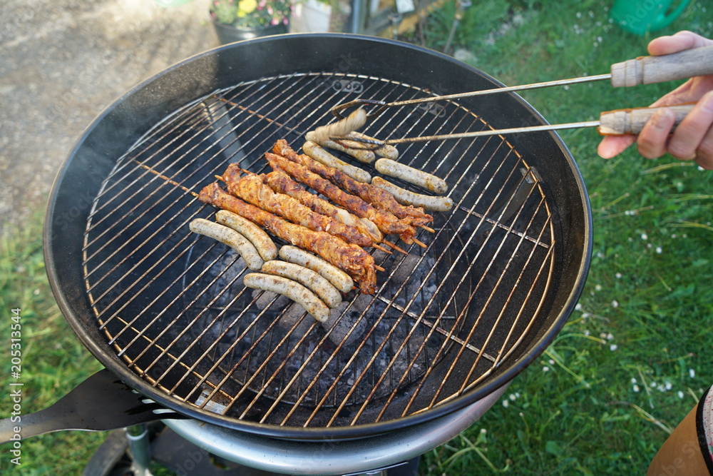 Sausages barbecue with a charcoal barbecue in the garden


