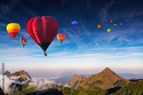 Aerial view colorful hot air balloons flying over with the mist at Doi Luang Chiang Dao with morning mist in Chiang Mai, Thailand..