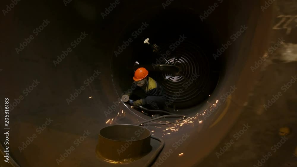 welder sits in pipe working with welding machine welder sits in pipe working with welding machine