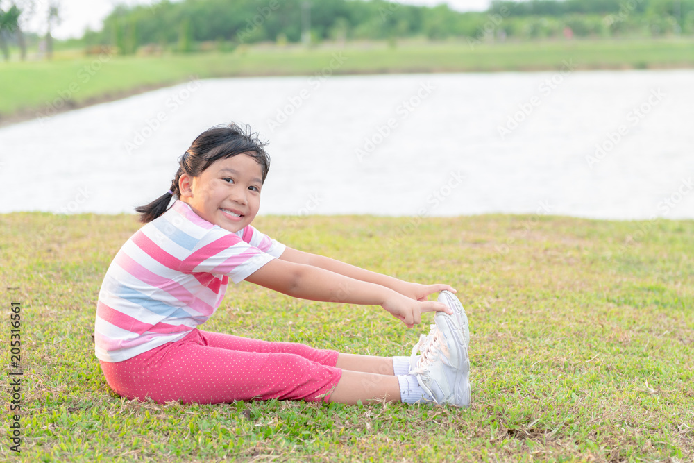 Happy girl exercise at health park on evening,