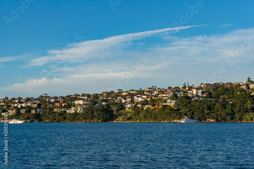 Suburb cityscape with waterfront property and bay of water