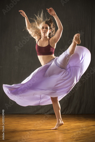 Young woman dancing in the studio on a hardwood floor.