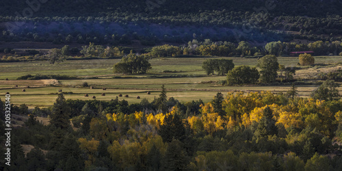 Vászonkép Foothills of San Juan Mountains in Autumn with hay bails in distance on Double R