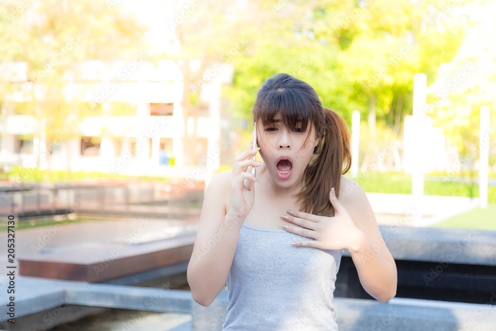 Portrait shocked beautiful woman: Attractive girl get surprised and shocking when her family tell her a bad news from oversea. Pretty girl feel sad, painful her mind and screaming, sunlight background Portrait shocked beautiful woman: Attractive girl get surprised and shocking when her family tell her a bad news from oversea. Pretty girl feel sad, painful her mind and screaming, sunlight background