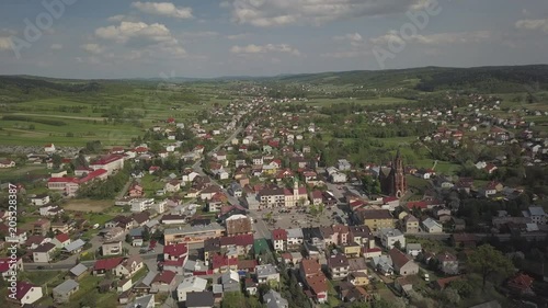 Panorama from a bird's eye view. Central Europe: The Polish town of Kolaczyce is located among the green hills. Temperate climate. Flight drones or quadrocopter. photo