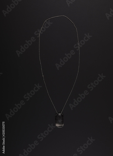 military sign with chain on a black background