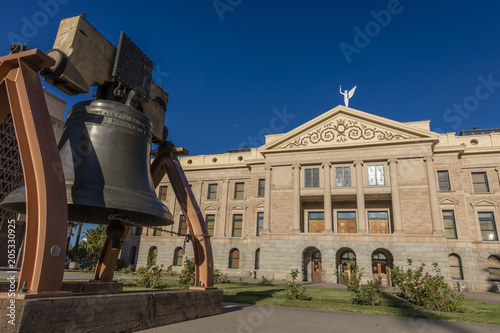 AUGUST 23, 2017 - PHOENIX ARIZONA - Replica of Liberty Bell in front of Arizona State Capitol Building at sunrise photo