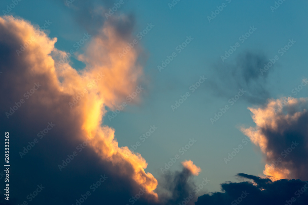 Colorful golden and blue dramatic sky with clouds at sunset
