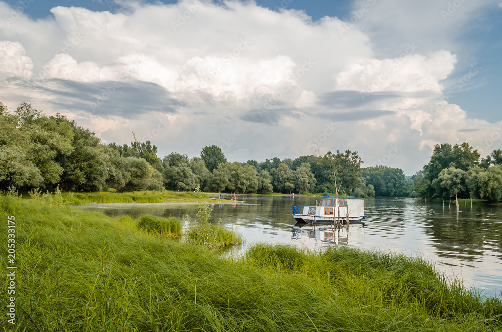 Fototapeta premium White small wooden boat on the lake