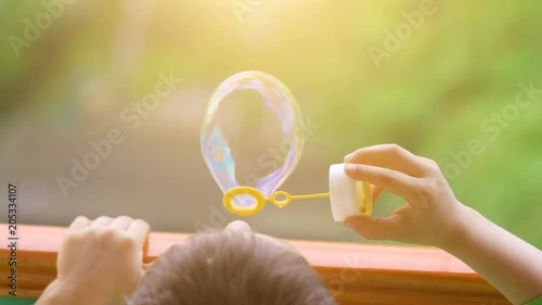 Little boy blowing soap bubbles