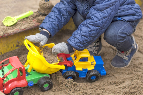 Children's sandbox, kids play sand building locks close-up