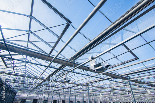glass roof with lighting equipment in a modern greenhouse