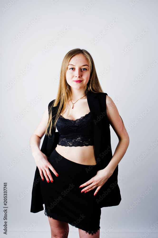 Girl model in black wear posed at studio on white background. Girl model in black wear posed at studio on white background.