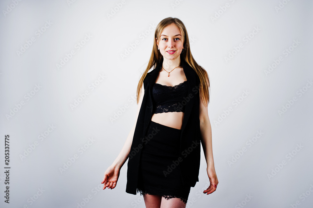 Girl model in black wear posed at studio on white background. Girl model in black wear posed at studio on white background.