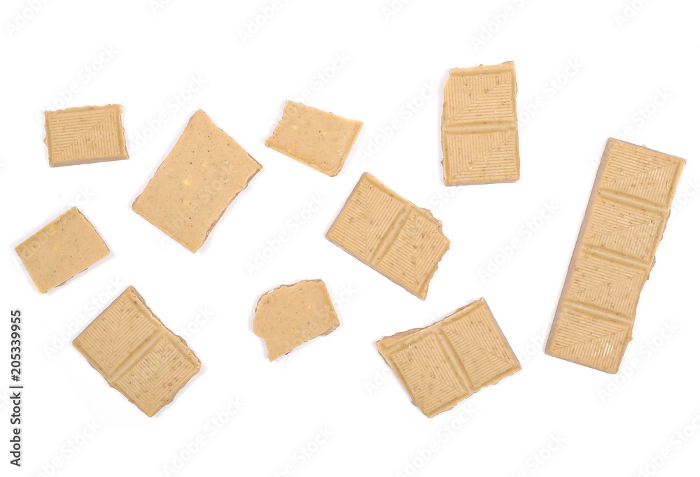 White nougat chocolate bar pieces with hazelnuts isolated on white background, top view White nougat chocolate bar pieces with hazelnuts isolated on white background, top view