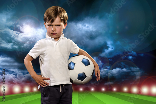 Young child holding a soccer ball © trattieritratti