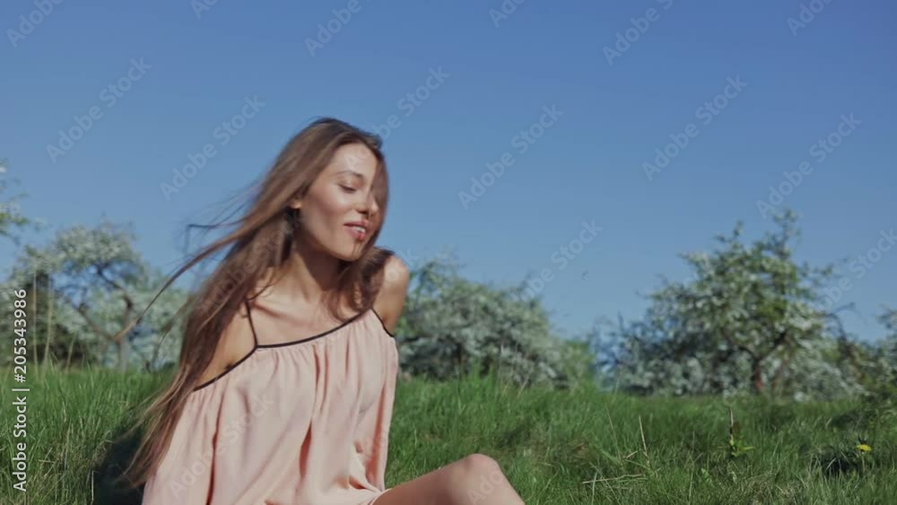 Young caucasian woman eats grapes in a blooming orchard. Outdoor lifestyle portrait. Slow motion video shooting by handheld gimbal Young caucasian woman eats grapes in a blooming orchard. Outdoor lifestyle portrait. Slow motion video shooting by handheld gimbal