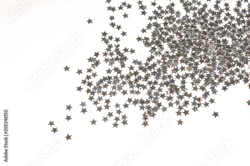 Glittering silver stars on white background photo