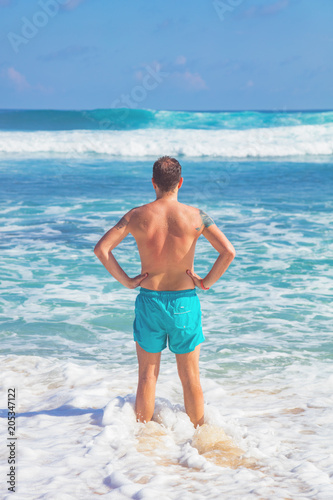 Man enjoying on a tropical ocean beach.