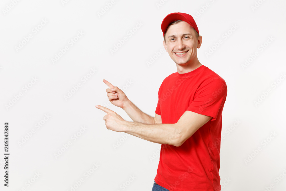 Delivery man in red uniform isolated on white background. Professional smiling male in cap, t-shirt working as courier or dealer, pointing index fingers aside gesture. Copy space for advertisement.