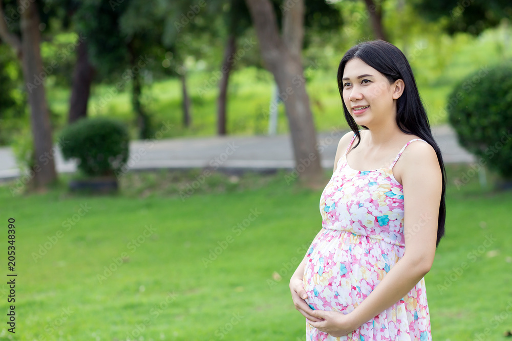 Beautiful pregnant woman relaxing outside in the park Beautiful pregnant woman relaxing outside in the park