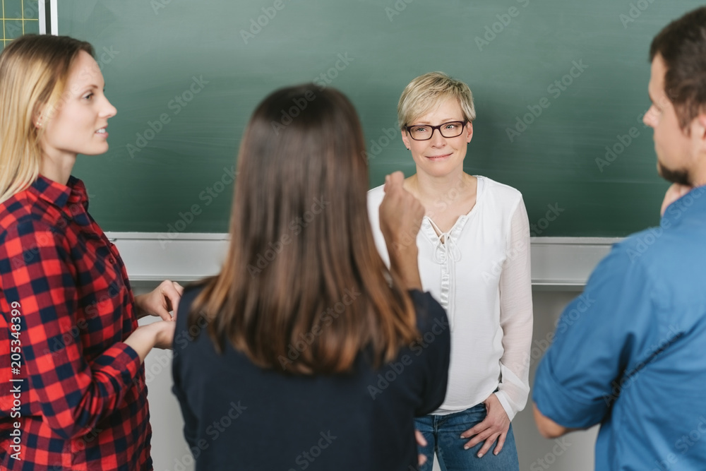 University students in a meeting with a lecturer University students in a meeting with a lecturer
