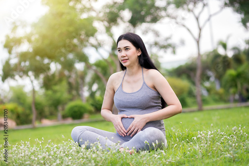 pregnant woman relaxing in the park