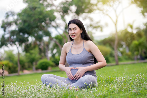 pregnant woman relaxing in the park